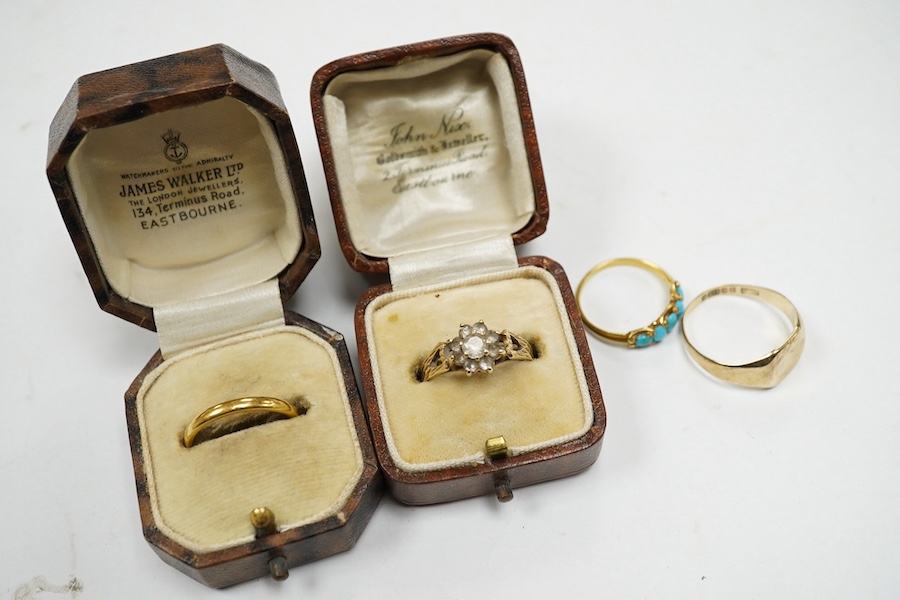 Four assorted rings, including a 22ct gold wedding band, 3.2 grams, two 9ct gold rings including a signet ring and a yellow metal and graduated five stone turquoise set half hoop ring, gross weight 7.3 grams. Condition -